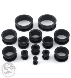 an assortment of black plastic parts on a white background