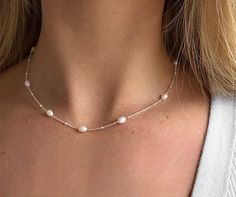 Our dainty beaded freshwater Pearl necklace is the perfect accessory for your everyday look. Layer with different sized necklace chains or wear on its own.  pair with our matching bracelet.  choose 925 Sterling silver and freshwater pearls or yellow gold plated with freshwater pearls Chain length- 41 + 6cm with extender chain.  Width- 4mm Depth- 4mm All orders are beautifully packaged in our SophieJean gift bags, perfect for gifting or as a special treat for yourself 🤍 Delicate Silver Beaded Necklace With Pearl Charm, Dainty Silver Beaded Necklace With Pearl Chain, Dainty Pearl White Beaded Necklaces, Dainty Pearl Beaded Necklaces In Silver, Dainty Silver Pearl Beaded Necklaces, Dainty Silver Pearl Beaded Necklace, Delicate Silver Beaded Necklace With Pearl Drop, Elegant Silver Pearl Necklace With Tiny Beads, Dainty White Pearl Necklace