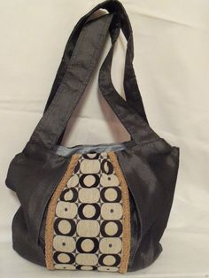 "One of a kind hobo, shoulder handbags have an upholstery grade fabric exterior with a 100% cotton fabric interior.  Purses are approximately 13\"W x 12\"H with 14\"H strap(s). This listing is for ONE purse - please make your selection from the drop down menu. Photo 1: Circles  Photo 2: Black Photo 3: Camel Circles purse has a silver/gray exterior accented with multi size and multi colored circles fabric in the center of the purse.  The circle fabric has a beige background with black, gray and dirty gold circles.  Center panel is flanked by curly gold gimp to coordinate with the dirty gold circles on the center panel fabric.   Purse has a light blue 100% cotton fabric interior; three pockets; one which is a zipper pocket.  Has (2) 14\"H straps and a magnetic closure. Black purse is made fr Black Fabric Bags For Daily Use, Black Fabric Bag For Daily Use, Black Fabric Shoulder Bag For Everyday Use, Black Fabric Shopping Bag, Elegant Everyday Shoulder Bag In Fabric, Elegant Everyday Fabric Shoulder Bag, Fabric Shoulder Bag With Zipper Pocket For Travel, Fabric Shoulder Bag With Zipper Pocket For Daily Use, Fabric Shoulder Bag For Shopping