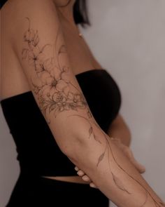 a woman with a flower tattoo on her arm