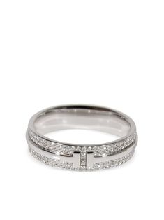 18kt white gold pavé setting white diamonds totalling 0.57ct eternity band signature Tiffany T design polished finish Condition: EXCELLENT. This previously owned item is in near-perfect condition with no signs of damage or use. Purchasing this item continues its narrative and reduces the environmental impact by avoiding the use of new resources needed to make the product from scratch, such as water, materials and electricity, and avoiding additional manufacturing impact. Learn more about what makes a product Conscious on our Conscious Criteria page Silver Tiffany Ring, Tiffany And Co Jewelry Tiffany & Co., Tiffany Setting Tiffany & Co., Timeless 14k White Gold Diamond Ring With Pave Setting, Luxury White Eternity Band With Pave Setting, Timeless White Gold Diamond Ring With Channel Set, 14k White Gold Wedding Ring With Pave Setting, Modern Diamond White Diamond Ring With Pave Setting, Modern Diamond White Ring With Pave Setting