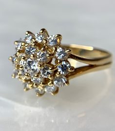 A whimsical and timeless Cubic Zirconia ring set in genuine 14k yellow gold. This is an ideal gift for her: girlfriend, wife, mother, daughter for any of life's milestones or special occasions: birthday, graduation, valentine's day, Mother's day, christmas, or holiday! Dazzling Gold Cluster Diamond Ring, Yellow Gold Cluster Ring With Cubic Zirconia, Yellow Gold Flower Ring With Brilliant Cut Cubic Zirconia, Dazzling Yellow Gold Cluster Ring With Prong Setting, Classic Yellow Gold Flower Ring With Prong Setting, Fine Jewelry Yellow Gold Cluster Ring With Cubic Zirconia, Fine Jewelry Yellow Gold Cubic Zirconia Cluster Ring, Yellow Gold Cubic Zirconia Cluster Ring In Fine Jewelry, Yellow Gold Cubic Zirconia Cluster Ring With Prong Setting