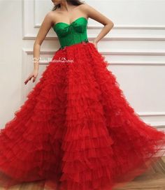 Details - Green and red color  - Designer tulle fabric  - Handmade corset  - Ball gown style with waist definition - For special occasions Elegant Tulle Ball Gown For Christmas, Elegant Christmas Tulle Ball Gown, Red Tulle Dress For Red Carpet, Elegant Tulle Dresses For Red Carpet, Red Fitted Bodice Organza Dress, Red Fitted Organza Ball Gown, Red Tulle Evening Dress For Gala, Red Tulle Ball Gown For Evening, Red Strapless Tulle Dress