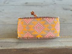 Absolutely gorgeous and bright, this sunshine inspired bracelet has a gorgeous western pattern and a wonderful combination of sunshine yellow, peach, coral and tan with rose gold. This unique, colorful pattern is a truly unique gift for yourself or that special girl in your life. * over 1.25 inches wide *6.5-8.5 inches long with adjustable button clasp *high quality delica seed beads * 2mm tan dyed leather cord * copper coated pewter button As with each item in our shop, this bracelet is handmade. It has a lifetime warranty, if it snags or breaks, we will repair or replace it for free. Please email questions to towercreationsbytc [!at] gmail.com Thank you for shopping and supporting my dream! Western Pattern, Girl Western, Handmade Gifts For Her, Bead Loom, Sunshine Yellow, Western Cowgirls, Special Girl, Cow Girl, Western Cowgirl