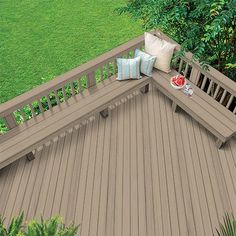 an overhead view of a wooden deck with pillows on it