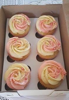 six cupcakes in a box with pink frosting