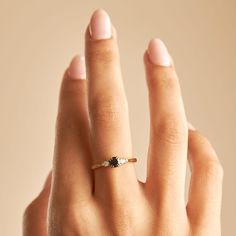 a woman's hand with a ring on it