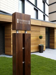 the entrance to staybridge suites is shown in front of a building with grass and potted plants