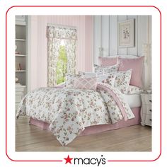 a pink and white bedroom with floral bedding