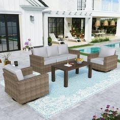 an outdoor living room with furniture next to a swimming pool