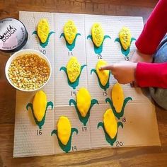 a child is making corn on the cob cookies with yellow icing and measuring tape