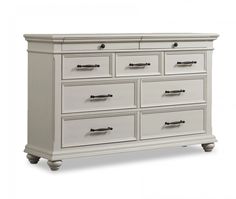 a white dresser with many drawers and handles