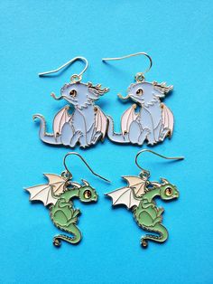 Arent these the cutest pair of green and blue dragons ?!?!?! These enamel earrings are light weight and would make a great gift too! We have other cute earrings as well... Come take a look! https://www.etsy.com/shop/MadeWithAlohaLA?ref=seller-platform-mcnav Handmade Blue Kawaii Jewelry, Themed Dangle Earrings, Themed Pierced Earrings As A Gift, Themed Earrings For Pierced Ears As Gift, Themed Gift Earrings, Novelty Blue Drop Earrings, Blue Drop Earrings Cute Jewelry, Blue Drop Earrings Cute Style, Blue Cute Drop Earrings