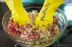 two yellow plastic gloves sticking out of a bowl filled with meat and veggies