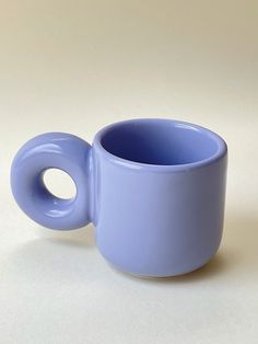 a blue cup sitting on top of a white table