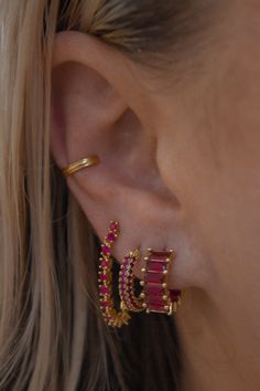 For the babes who love to sparkle, the Ruby Red Pave Hoop is a must. Red crystals cover this hoop and shine just right. 14mm x 3mm Gold plated over brass and finished with an IP tarnish resistant coating Surgical steel posts for sensitive ears Nickel and cadmium free by LUV AJ Ruby Ear Piercings, Red Earring Stack, Ear Inspo Jewelry, 3 Earring Stack, Red Piercing, Ruby Red Jewelry, Dream Piercings, Ear Peircings, Earring Stack