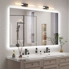 a bathroom with two sinks and a large mirror over it's counter top area