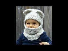 a baby wearing a knitted bear hat and scarf