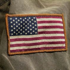 an american flag patch on the back of a jacket