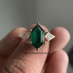 Unique Elongated Hexagon Emerald Engagement Rings Vintage Yellow Gold Green Gemstone Wedding Ring Birthstone Bridal Ring Women 𝐌𝐚𝐢𝐧 𝐒𝐭𝐨𝐧𝐞 𝐃𝐞𝐭𝐚𝐢𝐥𝐬 * Type: Emerald * Cut: Hexagon * Colour: Green * Clarity: D 𝐒𝐢𝐝𝐞 𝐒𝐭𝐨𝐧𝐞 𝐃𝐞𝐭𝐚𝐢𝐥𝐬 * Type: Simulated Diamond * Shape: Kite * Colour: D * Clarity: VVS1 𝐑𝐢𝐧𝐠 𝐃𝐞𝐭𝐚𝐢𝐥𝐬 * Metal Purity: Solid Gold (10k / 14k / 18k), 925 Sterling Silver * Metal Tone: White / Rose / Yellow * Stamp / Hallmarked: Yes * Free Engraving * Ring with Engagement ring box Customization * Diamond: Natural Diamond / Moissanite / CVD -Lab Grown / Cubic Zirconia 𝐑𝐮𝐬𝐡 𝐎𝐫𝐝𝐞𝐫 * Our standard production time is 1-2 weeks from the time of purchase. I am very happy to provide rush order service, the price is $20, the processing time would be 5 Vintage Emerald Rings Engagement, Vintage Emerald Diamond Ring, Vintage Rings Gemstone, Lab Grown Gemstone Ring, Gemstones For Rings, Emerald Ring Rectangle, Green Hexagon Engagement Ring, Types Of Gemstones Engagement Rings, Dark Green Stone Ring