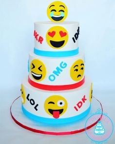 a three tiered cake with emoticions on it