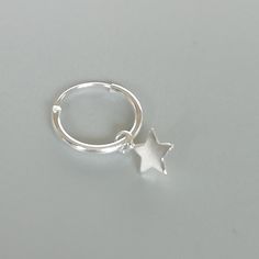 A PAIR of sterling silver hoops. Comes with a detachable tiny and delicate star charm. The charm is multipurpose and can be used with a neck or bracelet chain too. Dimension: Hoop- 12 x 1.5 mm Charm- 5 x 5 mm Drop length- 18 mm Price listed is for a PAIR of hoops. These earrings are made of 925 hypoallergenic sterling silver and comes with a 925 stamp. Can be packaged in a gift box. I can include a personal message from you if needed You are welcome to contact me at... bhavnakwintra1956@gmail.co Sterling Silver Huggie Earrings With Star Charm For Everyday, Minimalist Sterling Silver Star Huggie Earrings, Dainty Sterling Silver Star Huggie Earrings, Sterling Silver Star Huggie Earrings Minimalist Style, Minimalist Star-shaped Sterling Silver Huggie Earrings, Dainty Star-shaped Sterling Silver Huggie Earrings, Sterling Silver Star Shaped Minimalist Huggie Earrings, Minimalist Small Hoop Jewelry With Star Charm, Small Hoop Sterling Silver Earrings With Star Charm