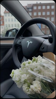 a bouquet of flowers sitting in the driver's seat of a car