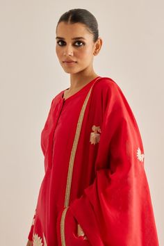 Red silk chanderi kurta with full sleeves and contrast metallic floral applique embroidery. Paired with trouser and embroidered dupatta with lace work border.
Components: 3
Pattern: Embroidered
Type Of Work: Floral Applique Work
Neckline: Round Neck
Sleeve Type: Full Sleeves
Fabric: Silk Chanderi
Color: Red
Other Details: 
Length:
Kurta: 48 inches
Sharara: 38 inches
Side slits
Kurta Closure: Front concealed placket
Occasion: Sangeet,Mehendi and Haldi - Aza Fashions Slub Silk Kurta With Dupatta For Puja, Eid Long Sleeve Slub Silk Palazzo Set, Eid Long Sleeve Palazzo Set With Gota Work, Festive Long Sleeve Designer Palazzo Set, Red Chanderi Churidar With Dabka Detail, Chanderi Sets With Gota Work And Long Sleeves, Long Sleeve Raw Silk Palazzo Set With Gota Work, Eid Long Sleeve Blouse Piece With Sheer Dupatta, Anarkali Churidar For Puja With Long Sleeves