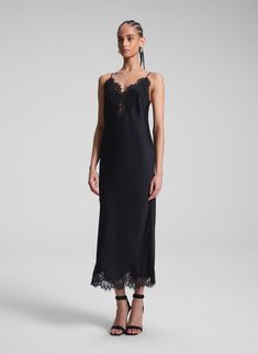 The Lennon Dress is crafted from lustrous black satin with captivating fluidity. This midi-length slip silhouette offers a more directional take on a classic, featuring delicate lace trimming along the neckline, hem, and low back, creating an alluring interplay between masculinity and femininity. Complete with slim, adjustable straps, it strikes a perfect balance between elegance and modern edge. Shop Dresses. Styling Tip: Pair it with minimalist heels and sculptural earrings, finishing with a s Elegant Lace Trim Slip Dress For Date Night, Chic Formal Slip Dress With Lace Trim, Elegant Lace Slip Dress For Date Night, Black Lace Trim Slip Dress For Formal Occasions, Lace Slip Dress For Night Out With Bias Cut, Chic Evening Slip Dress With Lace Trim, Elegant Black Slip Dress With Lace Trim, Elegant Black Lace Trim Slip Dress, Elegant Black Lace Slip Dress