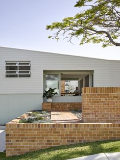 a modern home with brick steps leading up to the front door