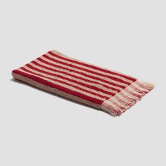 a red and white striped towel on a gray background