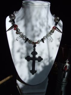 Wow !  Dark and Romantic !  Hand made with Two Polished Raw Quartz Crystals, Spikes, Bronze metal filigree beads, Czech beads with a hint of blood red, and vintage findings. Large Antique Silver Tone Gothic Cross measures 2''. Necklace measures 18'' with toggle clasp. *SEE OTHER NECKLACES IN THE VAMPIRE THEME ! Handmade Vampire Style Necklace For Gift, Gothic Beaded Necklaces For Halloween, Fantasy Necklaces For Halloween Festival, Halloween Gothic Beaded Necklace, Gothic Metal Necklace With Beaded Chain, Gothic Necklaces With Beaded Metal Chain, Gothic Cross Necklace For Festivals, Gothic Beaded Cross Jewelry, Handmade Vampire Necklaces For Halloween