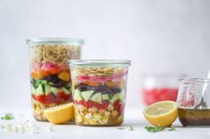 three mason jars filled with different types of salads and ingredients to make the salad