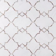 an intricate white marble tile with silver lines and hearts on it's sides, as well as the top part of its design