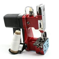 a sewing machine with a spool of thread on it's side and an object in the foreground