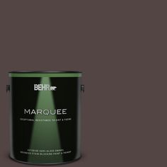 the behr marquee paint is shown in dark green and has a black base