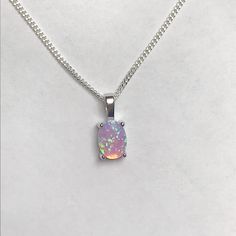 Sterling Silver Pink Fire Opal Necklace Dainty and minimalist necklace Metal: All components are made from solid .925 Sterling Silver Stone: 8mm x 6mm Lab created Opal Measurement: pendant height is 14mm including bail Choose Chain Length Please feel free to Convo me with any questions before purchasing. Please view policy before purchasing Other Opal Necklaces can be found here https://www.etsy.com/shop/LinksAndStones?ref=ss_profile§ion_id=24284450 Thank You For Visiting My Shop Minimalist Sterling Silver Oblong Jewelry, Classic Sterling Silver Necklace With Oval Cabochon, Minimalist Oval Birthstone Necklace, Silver Opal Necklace With Oval Pendant, Oval Opal Necklace With Polished Finish, Minimalist Silver Oval Necklace, Silver Opal Oval Necklace, Oval Sterling Silver Birthstone Necklaces, Sterling Silver Birthstone Necklace With Oval Cabochon