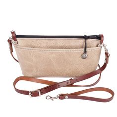 ◄Details This convenient size is ideal for keeping essentials together in a larger bag for the big haul. Then taking only what you need when you're out and about. Wear it crossbody for shopping, work, school, or travel. Or convert it to a wristlet for a day or night out. NEW Adventure leather is rugged yet soft and sophisticated. Dimensions: 9.75" W x 5.5" H x 2" Adjustable detachable Cross-body Strap: 57" - 49" Plus a detachable wristlet strap option Exterior back pocket, perfect for your phone Interior zippered divider pocket ◄The Leather Leather: Adventure Color: DesertOur charming Adventure leather is both resilient and beautiful with a soft, pebbled texture. Rustic yet sophisticated, its slightly buffed surface has a lovely natural two-toned effect and is very easy to care for. Small Everyday Beige Shoulder Bag With Cell Phone Pocket, Beige Crossbody Satchel For Everyday Use, Everyday Beige Bag With Cell Phone Pocket, Everyday Crossbody Satchel, Everyday Crossbody Satchel With Cell Phone Pocket, Everyday Crossbody Shoulder Bag With Cell Phone Pocket, Beige Satchel With Adjustable Strap For Everyday Use, Everyday Beige Crossbody Shoulder Bag, Versatile Satchel With Cell Phone Pocket For Everyday Use