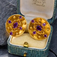 These opulent earrings contain round and oval cut amethysts prong set amongst gold beads and textured design motifs. The concave disk construction is reminiscent of ancient designs. We have left a soft patina on these earrings, which are finished with screw backs for non-pierced ears. The screw backs are stamped NAOMI. Please note that one amethyst is chipped, but does not detract from the beauty of these earrings. Opulent Earrings, Antique Engagement Rings Sapphire, Estate Jewelry Rings, Wedding Ring Diamond Band, Design Motifs, Amethyst Studs, Ancient Designs, Textured Design, Antique Engagement Rings