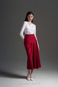 "The Jonette Draped Skirt is the epitome of elegance and sophistication. This mid-length skirt features exquisite pleated draped details on the left side, adding a touch of artistry to your ensemble. With a little high-waisted design, this skirt exudes a formal and academic vibe, perfect for various occasions. The closed-fit effect around the seat and thigh creates a flattering silhouette. Crafted from high-quality Ponte de Rome, this skirt has a buttery soft, suede-like feel. Pair it with the Y Elegant Long Red Pencil Skirt, Elegant Red Long Pencil Skirt, Elegant Pleated Mini Wrap Skirt, Elegant Red Asymmetrical Skirt, Fitted Midi Draped Skirt With Gathered Detail, Formal Pencil Wrap Skirt With Lining, Red Fitted Long Wrap Skirt, Elegant Fitted Red Wrap Skirt, Elegant Red Fitted Wrap Skirt