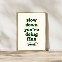 a poster with the words slow down you're doing fine in green on it