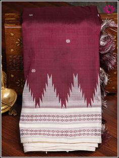 Berhampuri silk was introduced at Berhampur town in 14th century AD by the Mohuri Kings. It is known as ‘Silk City’ for its pure silk weaves. This Berhampuri silk saree is one of the traditional weaving and handloom heritage from Odisha. Experience class and elegance with this Maroon and Half white Berhampuri double pallu pure silk saree with phoda kumba(temple) borders. Extended double pallu in Half white and custom hanmade tassels on pallu adds grace to the saree. Part of the package is an uns Traditional White Tussar Silk Wear With Border, White Tussar Silk Traditional Wear With Border, White Tussar Silk Dupatta With Woven Motifs, White Saree With Woven Motifs For Traditional Ceremonies, White Wedding Saree With Weaving Work, White Tussar Silk Saree With Woven Motifs, White Saree With Woven Motifs In Traditional Drape, Navratri Katan Silk Saree With Woven Motifs, White Saree With Woven Motifs For Festivals