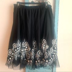 Tasha Polizzi Skirt. Beautiful Black Sheer Skirt With White Embroidery. Elastic Waist, Fully Lined. Tag Size L. Tags Were Taken Off Skirt, However It Was Never Worn. Embroidered Flowy Skirt For Party, Embroidered Flowy Party Skirt, Embroidered Party Skirt, Flowy Full Skirt With Embroidery, Flowy Full Embroidered Skirt, Elegant Embroidered Tiered Skirt, Black Embroidered Flowy Skirt, Black Skirt With Floral Embroidery, Black Floral Embroidered Skirt