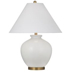 a white lamp with a gold base and a white shade on the top of it