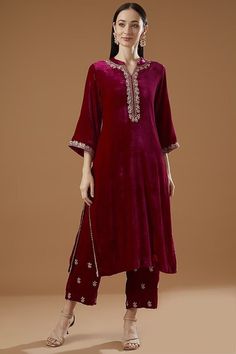 Featuring a pink kurta in velvet base with hand embroidery. It is paired with matching embroidered palazzo pants. This product will be shipped to you after 1-2 weeks from the date of order placed. All custom made orders are not returnable. Pls contact for Size chart and for other more colors Request You :To provide contact details for courier services. {VARIATION MAY COME DEPENDING UPON AVALIBILITY OF LACES OR GOTTA PATI or TUSSELS} NOTE:  1) Visual Samples on website may differ slightly from actual product due to light & effects during photography (Length & Breadth have 1 n 1.5 inches +/-). 2) Before placing order ,pls confirm product n color availability and  For Wholesale Order MOQ is 5 Pieces of any color/Pattern on +91 7903893945 & +91 8447750028(WhatsApp) Bridal lehanga ,indian weddi Valvet Suits, Chudidhar Designs, Marriage Suits, Velvet Dresses Outfit, Velvet Suit Design, Velvet Dress Designs, Velvet Dresses, Salwar Kamiz, Red Lehenga