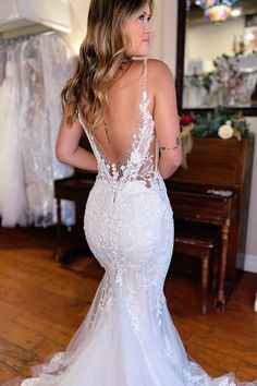 a woman in a wedding dress looking back