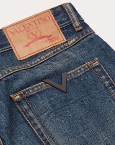 Valentino denim trousers with metallic V Detail - Carrot fit - Metallic V Detail on back pocket - Five pockets - Composition: 100% Cotton - Length: 101 cm / 39.8 in. in an Italian size 30 - Leg opening: 17.80 cm / 7.0 in. an Italian size 30 - The model is 187 cm / 6'1" tall and wears an Italian size 30 - Made in Italy The look of the model is completed by a Valentino Garavani Vlogo Signature Bag and Valentino Garavani Rockstud Shoes. Luxury Denim Blue Bottoms With Five Pockets, Luxury Denim Straight Leg Bottoms, Luxury Straight Leg Denim Bottoms, Luxury Straight Leg Jeans With Belt Loops, Luxury Straight Leg Denim Blue Bottoms, Designer Denim Straight Leg Pants, Designer Straight Leg Denim Pants, Luxury Straight Leg Jeans, Designer Denim Bottoms With Pockets