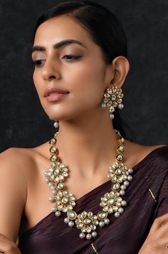 Gold Plated Kundan Inspired Necklace with Earrings Necklace Size - 22 inches. Closure - Dori Earrings size- 4.5 cm Closure- Pushback. Style Tip - Wear this with your choicest of summer fashion and chiffon sarees. We love teaming this with solid whites and bold blacks.Indian baratis who don't want to go overboard with red, this is a perfect solution to your pastel wedding dresses and floral gowns. A perfect companion for pastel lehengas and Indian wedding dresses. Handcrafted in Jammu and Kashmir Temple Jewelry Gota Work Necklace For Diwali, Diwali Temple Jewelry Necklace With Gota Work, Chandbali Necklace With Gota Work For Puja, Chandbali Gota Work Necklace For Puja, Temple Jewelry With Mirror Work For Puja, Kundan Jewelry With Gota Work For Puja, Temple Jewelry Chandbali Necklace With Mirror Work, Chandbali Jewelry With Mirror Work For Puja, Chandbali Mirror Work Jewelry For Puja