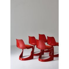 four red chairs sitting next to each other