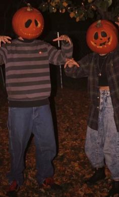 two young boys with pumpkin heads on their faces